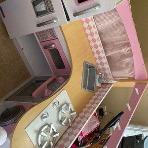 A toy kitchen for a kid.